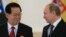 FILE - North Korea's ambassador to Russia, Kim Hyun Joon, pictured with Russian President Vladimir Putin in November 2014, says "it is well-known that the DPRK is already a nuclear state in both content and form."