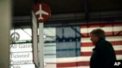 A sign directs travelers to their gates at Rhode Island T.F. Green International Airport in Providence, R.I., April 19, 2022. 