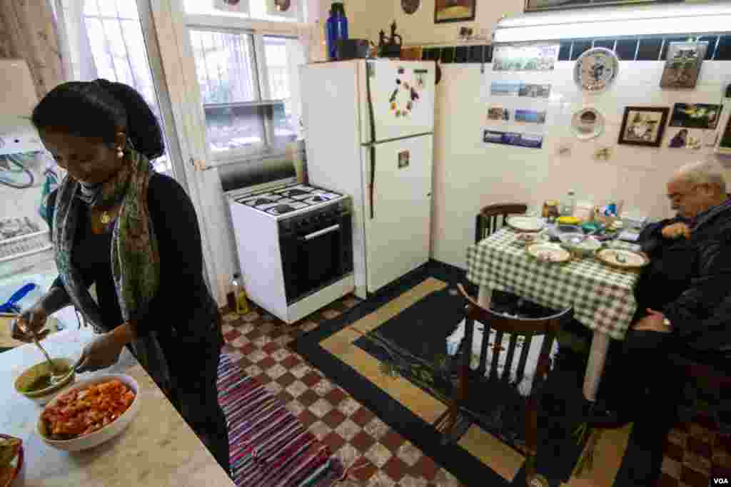 Rahel Zegeye serves lunch to her employer, with whom she has a good relationship. Many others are not so fortunate, with suicide rates high among domestic migrant workers. (John Owens/VOA)
