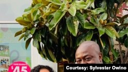 Sylvester Owino with his daughter and wife.