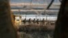 South Korean army soldiers patrol along a barbed-wire fence near the border village of Panmunjom in Paju, South Korea, Mar. 27, 2013. 