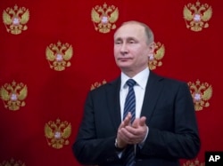 Russian President Vladimir Putin applauds during a signing ceremony with Slovenian President Borut Pahor (not pictured) after their talks at the Kremlin in Moscow, Russia, Feb. 10, 2017.