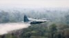 In this photo released by Brazil Ministry of Defense, a C-130 Hercules aircraft dumps water to fight fires burning in the Amazon rainforest, in Brazil, Aug, 24, 2019.