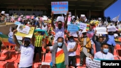 Ethiopian pro-government demonstrators carry placards as they attend a rally to protest against the US action over alleged human rights abuses during the conflict in the Tigray region, in Addis Ababa, Ethiopia, May 30, 2021. 