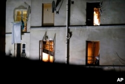 Bullet holes are seen around a window on the back side of the apartment after security forces conduct raid against group of extremists in Saint-Denis, near Paris, Nov. 18, 2015.