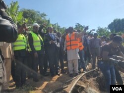 Emmanuel Nganou Djoumessi, le ministre des Travaux publics (en costume), sur les lieux du sinistre.