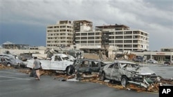 Damaged vehicles litter the parking lot of St. John's Hospital in Joplin, Missouri, after a tornado hit the Missouri city on Sunday, May 22, 2011