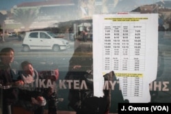 Refugees wait for a bus in Mytilene, the capital city of Lesvos.