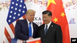 FILE - President Donald Trump poses for a photo with Chinese President Xi Jinping during a meeting on the sidelines of the G-20 summit in Osaka, Japan, Saturday, June 29, 2019. (AP Photo/Susan Walsh)