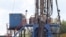 FILE - A crew works on a gas-drilling rig at a well site for shale-based natural gas in Zelienople, Pennsylvania, June 25, 2012. There has been a dramatic rise in earthquakes associated with wastewater from oil and gas drilling sites.