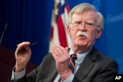 FILE - National Security Adviser John Bolton unveils the Trump administration's Africa strategy at the Heritage Foundation in Washington, Dec. 13, 2018.
