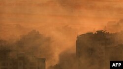 Smoke envelops a neighborhood of Beirut's southern suburbs near one of the runways of Beirut International Airport following an Israeli airstrike on Oct. 19, 2024.