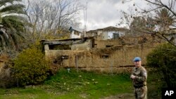 A UN soldier stands inside the UN buffer zone divides the Greek south and the Turkish north in the divided capital Nicosia, Cyprus, Jan. 4, 2017. Cyprus' so-called guarantors Greece, Turkey and Britain will gather in Geneva next week to thrash out the toughest aspect of a peace deal.
