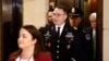 Army Lieutenant Colonel Alexander Vindman, a military officer at the National Security Council, center, arrives on Capitol Hill in Washington, Oct. 29, 2019, to be interviewed as part of the impeachment inquiry into President Donald Trump.