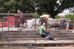 Workers dig up the remains of Confederate Gen. Nathan Bedford Forrest and his wife to move the bodies from Health Sciences Park, June 4, 2021, in Memphis, Tenn.