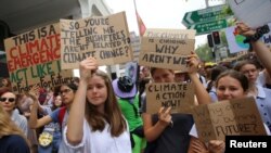 Aktivis siswa dari gerakan peduli iklim "School Strike for Climate Australia (SS4C)" menggelar aksi solidaritas di luar gedung kantor Partai Liberal Australia di Sydney, Australia, 29 November 2019. 
