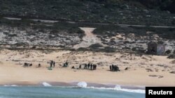 FILE - An aerial view shows Israeli soldiers cleaning tar from the sand after an offshore oil spill drenched much of Israel's Mediterranean shoreline, at a beach in Atlit, Israel, Feb. 22, 2021. 
