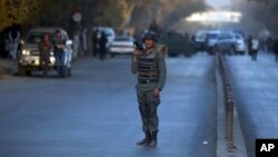 A policeman stands guard at the site of a suicide attack in central Kabul, Afghanistan, Oct. 31, 2017. 