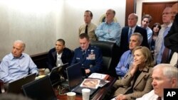 President Barack Obama and Vice President Joe Biden, along with members of the national security team, receive an update on the mission against Osama bin Laden in the Situation Room of the White House, May 1, 2011. Seated, from left, are: Brigadier Genera