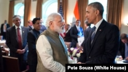 FILE - President Barack Obama and Indian Prime Minister Narendra Modi talk in the Cabinet Room of the White House, June 7, 2016.