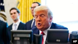 President Donald Trump speaks while on a phone call with the leaders of Sudan and Israel in the Oval Office of the White House, Oct. 23, 2020, in Washington.
