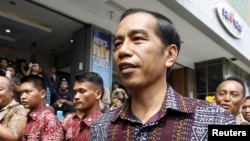 FILE - Indonesia's President Joko Widodo visits a store near Thursday's gun and bomb attack in central Jakarta, Jan. 15, 2016.
