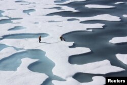 FILE - The crew of the U.S. Coast Guard Cutter Healy, in the midst of its ICESCAPE mission to study sea ice, retrieves supplies in the Arctic Ocean, July 12, 2011.
