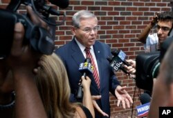 FILE - Sen. Robert Menendez, D-N.J., answers a reporter's question in Union Township, N.J., July 27, 2015.