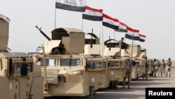 FILE - Iraqi security forces ride in vehicles towards to Mosul, Feb. 21, 2016. The city has been now been controlled by IS militants for more than two years.