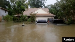 Houses and cars are seen partially submerged by flood waters from tropical storm Harvey in east Houston, Texas, Aug. 28, 2017. 