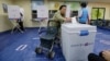 FILE - A woman casts her ballot for presidential election at a polling station in Seoul, South Korea, May 9, 2017.