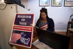 Le'Ana Freeman from Washington registers before casting vote on the Super Tuesday for U.S. Democrats Abroad multi-location global primary, at Foreign Correspondents' Club of Thailand in Bangkok, March 3, 2020.