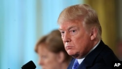 Presiden Donald Trump dan Kanselir Jerman Angela Merkel mendengarkan berbagai pertanyaan dalam konferensi pers di Ruang Timur Gedung Putih, Washington, Jumat, 27 April 2018.