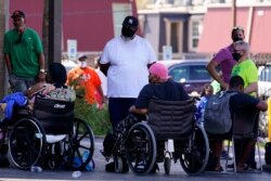 Occupants depart the Renaissance Place senior living apartments in the aftermath of Hurricane Ida, in New Orleans, Louisiana, Sept. 3, 2021.