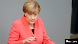 German Chancellor Angela Merkel gestures as she delivers the government's declaration on current refugee crisis at the lower house of parliament Bundestag in Berlin, Sept. 24, 2015.