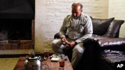 Merhi Alshebli rolls a cigarette in his living room in Juan Lacaze, Uruguay. Last November, locals welcomed Alshebli, his wife and their 15 children, who were fleeing Syria's civil war.