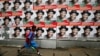 A schoolgirl walks past campaign posters in support of Nigeria's President Goodluck Jonathan along a road in Ikoyi district in Lagos, Feb. 13, 2015. 