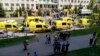 Ambulans dan truk polisi diparkir di sebuah sekolah setelah penembakan, di Kazan, Rusia, Selasa, 11 Mei 2021. Media Rusia melaporkan bahwa beberapa orang telah tewas dan terluka dalam penembakan di sekolah tersebut. (AP Photo)