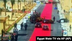 Egyptian President Abdel-Fattah el-Sisi's motorcade drives on a red carpet during a trip to open social housing projects in a suburb of Cairo, Egypt. 