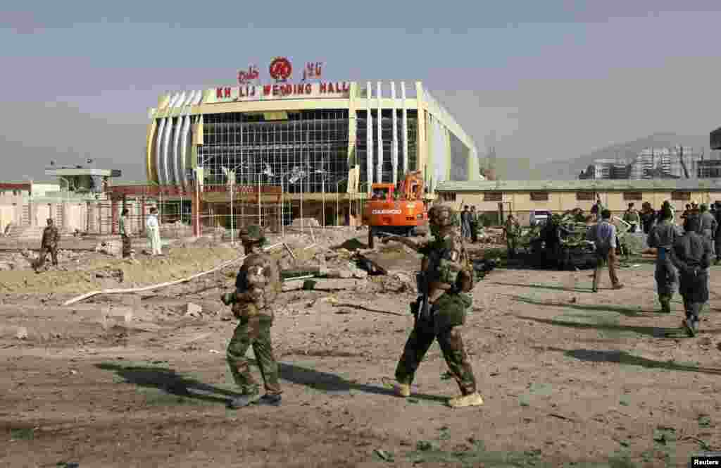 A young displaced girl carries a bucket of water back to her makeshift shelter at a United Nations compound. The compound has become home to thousands of people displaced by the recent fighting, Juba, South Sudan, Dec. 31, 2013.