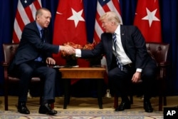 FILE - U.S. President Donald Trump shakes hands with Turkish President Recep Tayyip Erdogan during a meeting at the Palace Hotel during the United Nations General Assembly in New York, Sept. 21, 2017.