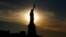 The sun rises behind the Statue of Liberty a day before the United States celebrates its independence, July 3, 2016, in Jersey City, N.J. 