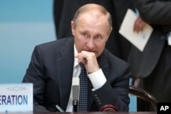 Russian President Vladimir Putin sits before the start of the opening ceremony of the G-20 Summit in Hangzhou in eastern China's Zhejiang province, Sunday, Sept. 4, 2016.