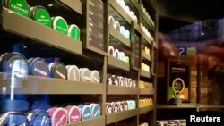 FILE - Moist powder tobacco snus cans are seen on shelves at a Swedish Match store in Stockholm, Sweden, Oct. 24, 2018.