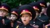 Young cadets sing the national anthem during rehearsal of a ceremony on the first day of school at a cadet lyceum in Kyiv, Ukraine, Sept. 1, 2022.