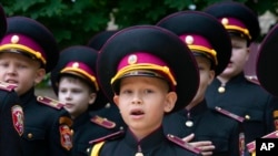 Young cadets sing the national anthem during rehearsal of a ceremony on the first day of school at a cadet lyceum in Kyiv, Ukraine, Sept. 1, 2022.