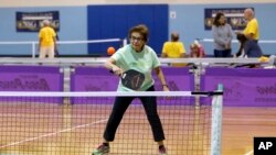 FILE - Leurene Hildenbrand, 85, competes in mixed doubles pickleball action during the Florida Senior Games presented by Humana on Saturday, Dec. 9, 2017 in Clearwater, Florida. (Brian Blanco/AP Images for Humana)