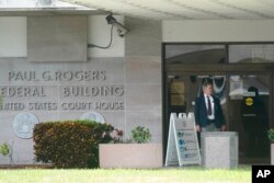 A security guard stands outside the Paul G. Rogers Federal Building and U.S. Courthouse, in West Palm Beach, Fla., Sept. 1, 2022.