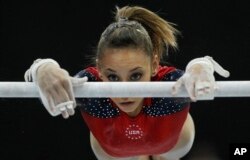 FILE - In this Oct. 17, 2010, photo, Mattie Larson of the U.S. performs on the uneven bars. Larson, who was molested by Larry Nassar and was among the nearly 250 who gave victim impact statements during his sentencing, said the doctor cleared her one time to train at the Bela and Martha Karolyi complex in Texas on an ankle that turned out to be fractured.