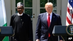 President Donald Trump and Nigerian President Muhammadu Buhari arrive for a news conference in the White House Rose Garden in Washington, April 30, 2018. 